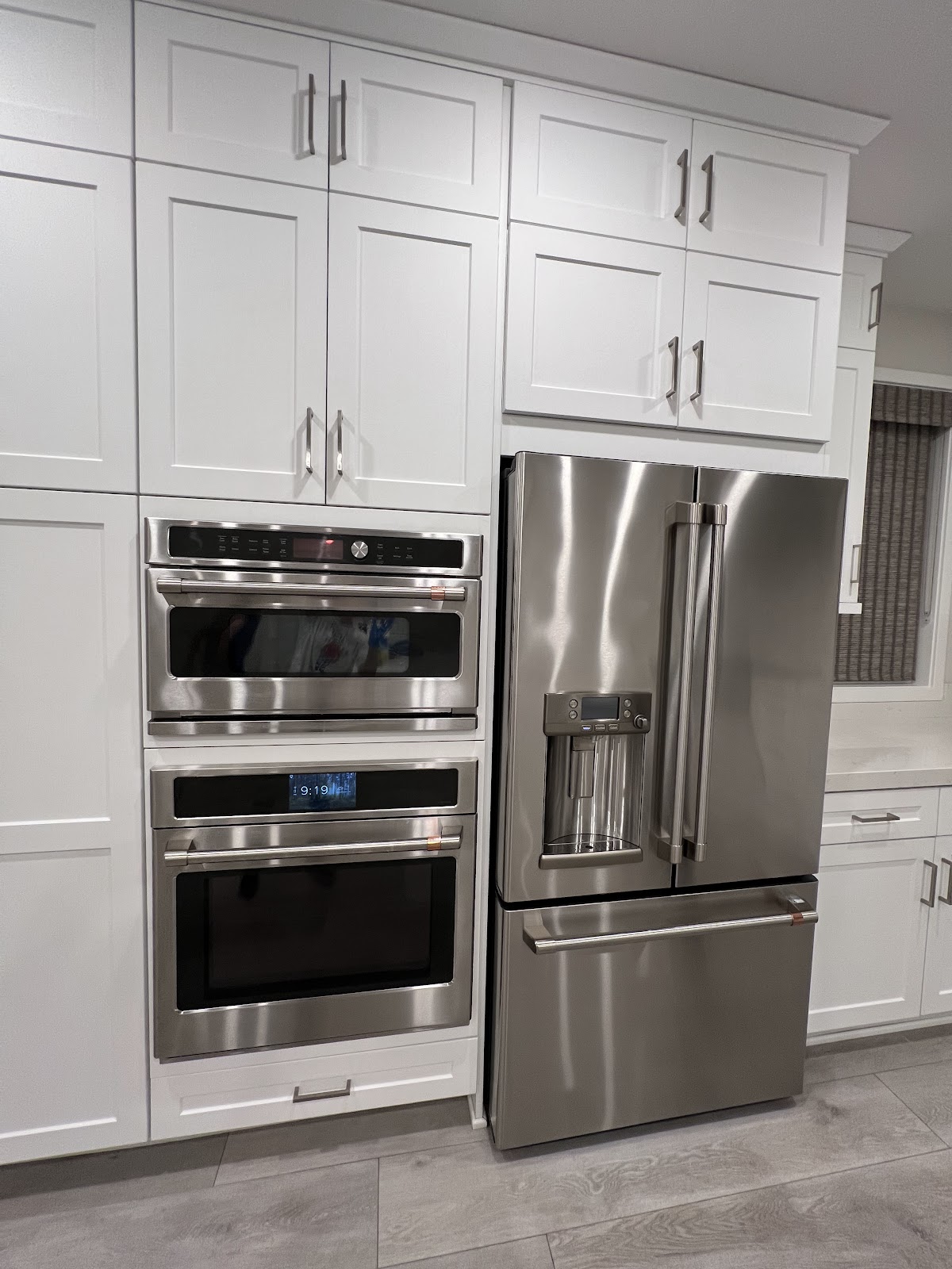 Modern kitchen appliances including an oven and refrigerator.