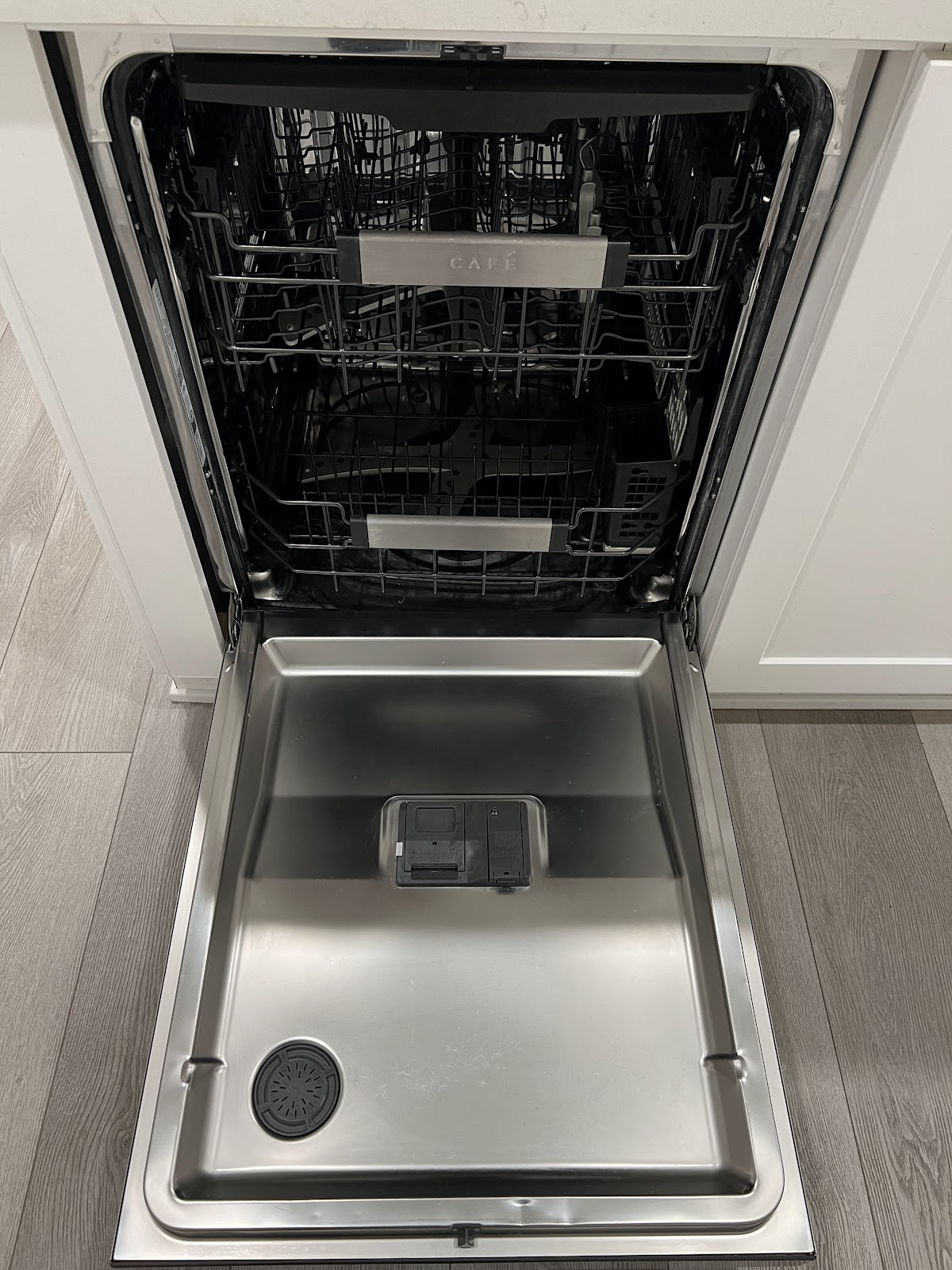 Open dishwasher showing its interior.